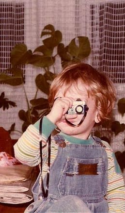 4 year old Philippe Roy with a toy camera that shoots water out of the lens.